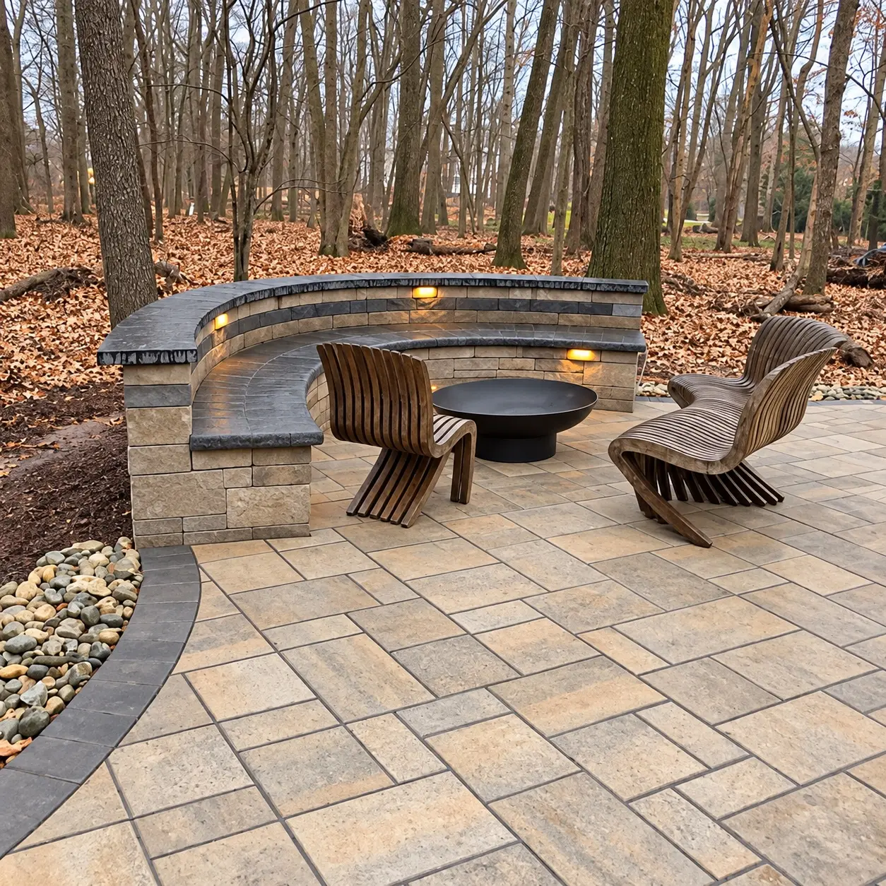 Curved illuminated masonry seating wall around a paver fire-pit area